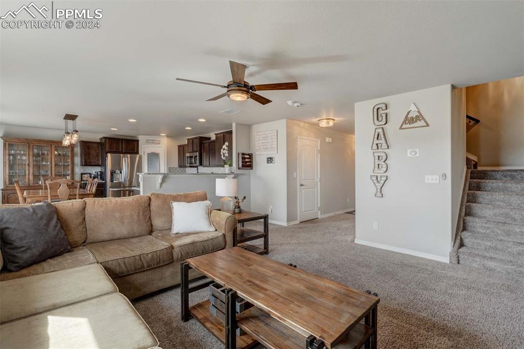 11305 Avena Road Peyton, CO 80831 - Photo 7 of 47 a living room with furniture and kitchen view