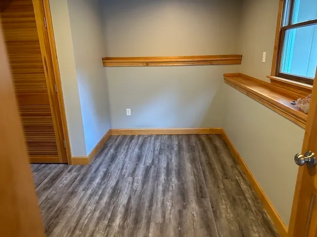 a view of a room with wooden floor and a staircase