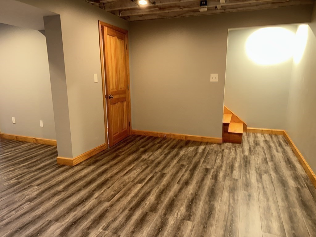 101 Minechoag Heights, Unit 101 Ludlow, MA 01056 - Photo 17 of 20 a view of a room with wooden floor and a staircase