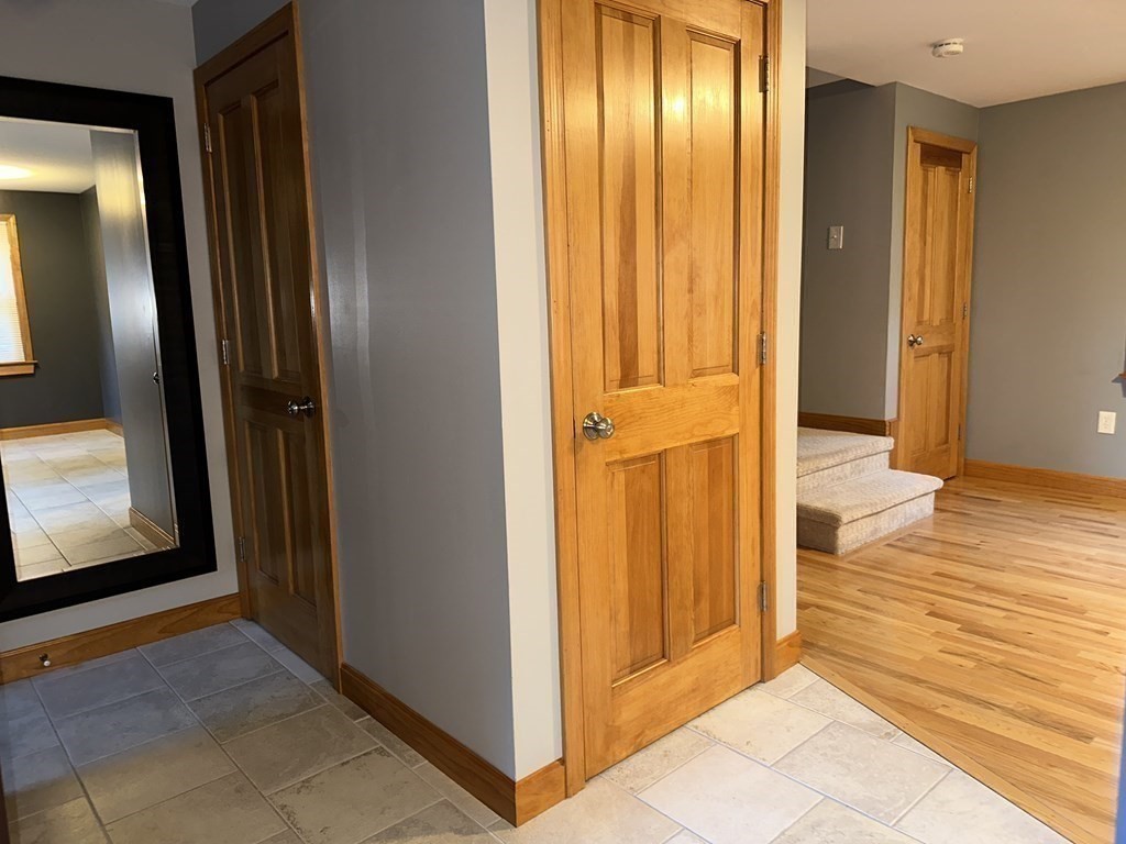 101 Minechoag Heights, Unit 101 Ludlow, MA 01056 - Photo 5 of 20 a view of a hallway with wooden floor and doors