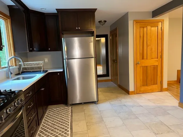 a kitchen with a refrigerator and a sink