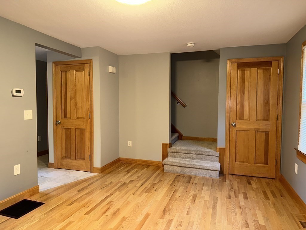 101 Minechoag Heights, Unit 101 Ludlow, MA 01056 - Photo 9 of 20 a bedroom with a bed and wooden floor