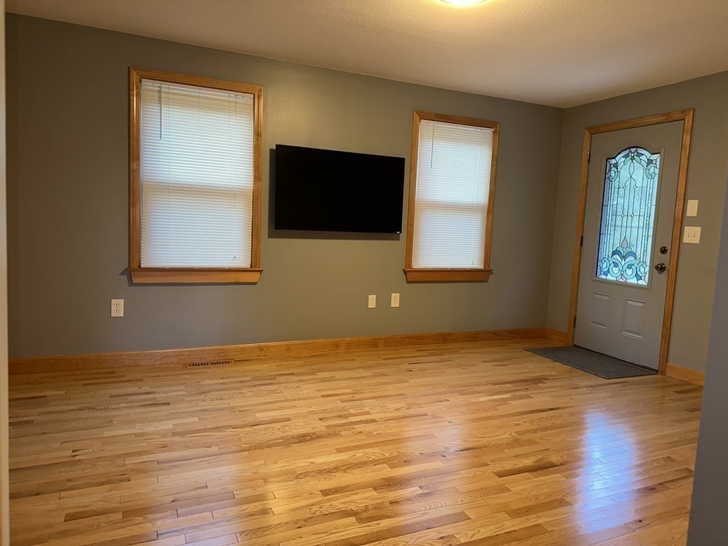 101 Minechoag Heights, Unit 101 Ludlow, MA 01056 - Photo 10 of 20 a view of an empty room with window and wooden floor