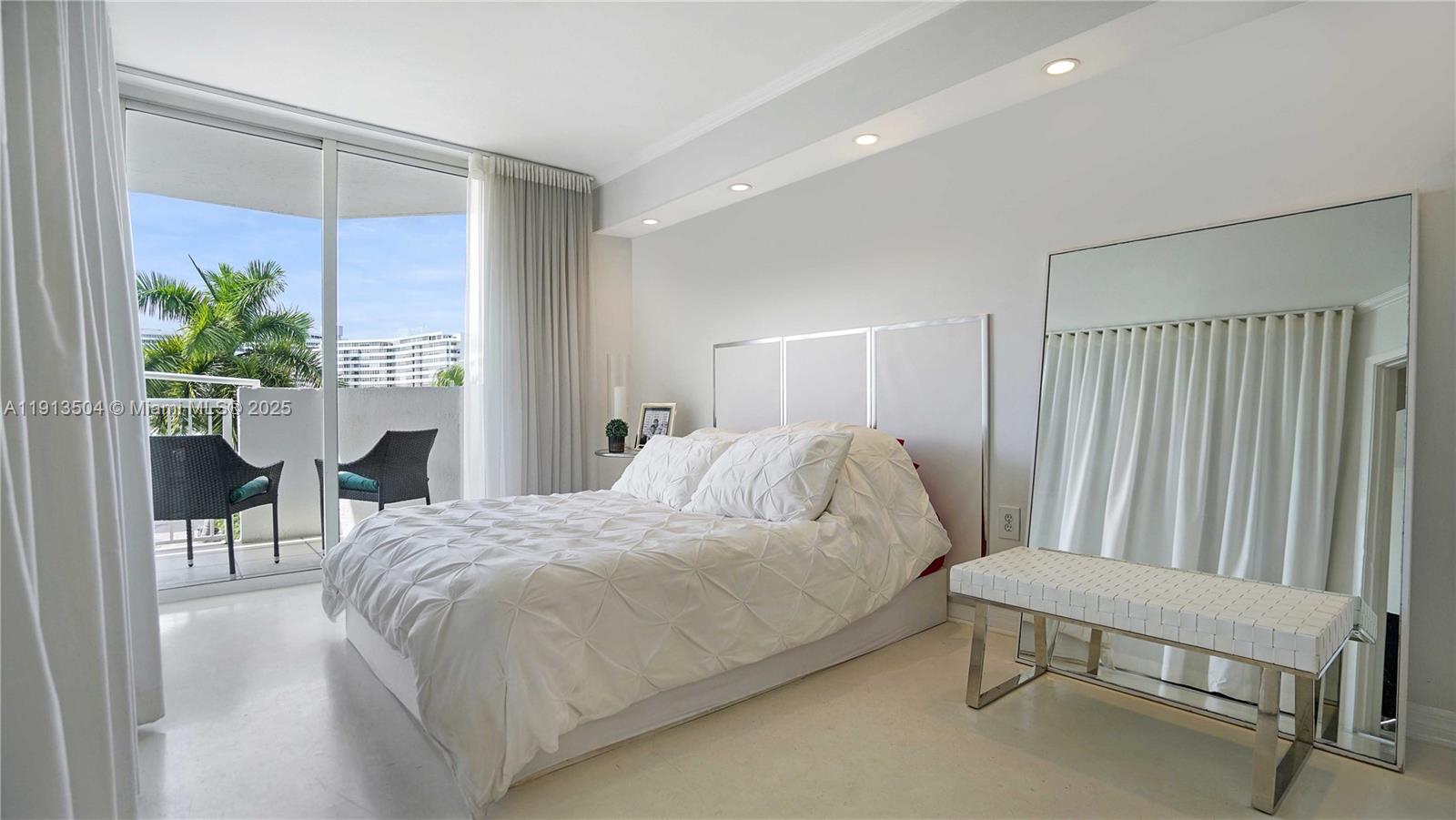1621 Bay Road, Unit 606 Miami Beach, FL 33139 - Photo 11 of 32 a bedroom with a bed and a table