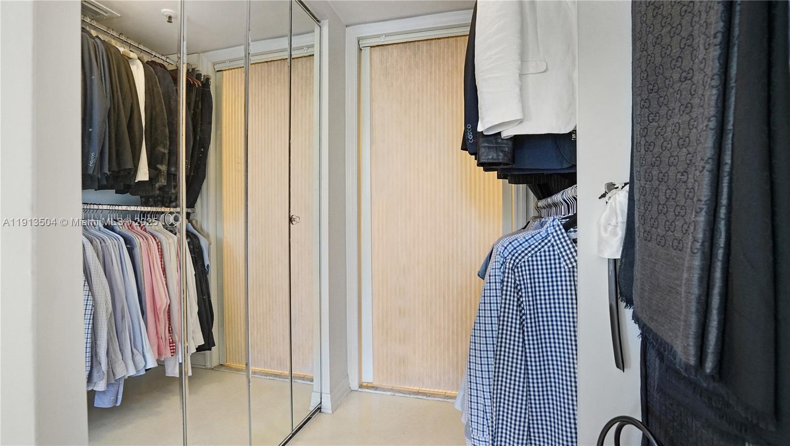 1621 Bay Road, Unit 606 Miami Beach, FL 33139 - Photo 13 of 32 a view of walk in closet with clothes and shoes
