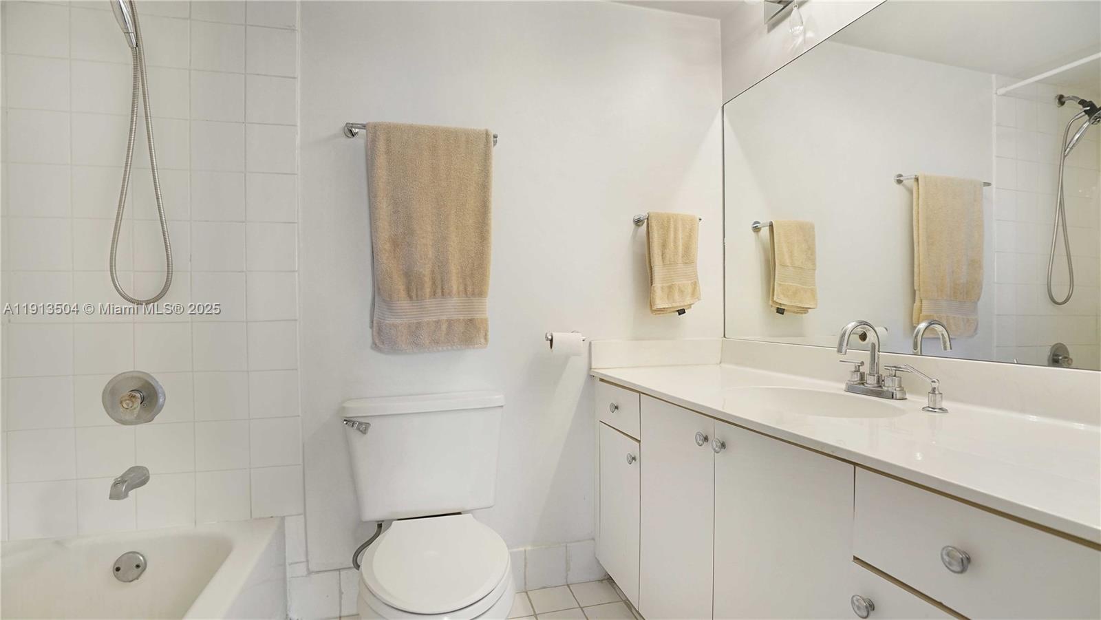 1621 Bay Road, Unit 606 Miami Beach, FL 33139 - Photo 14 of 32 a bathroom with a sink a toilet and shower