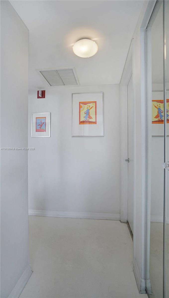 1621 Bay Road, Unit 606 Miami Beach, FL 33139 - Photo 19 of 32 a view of a hallway with closet