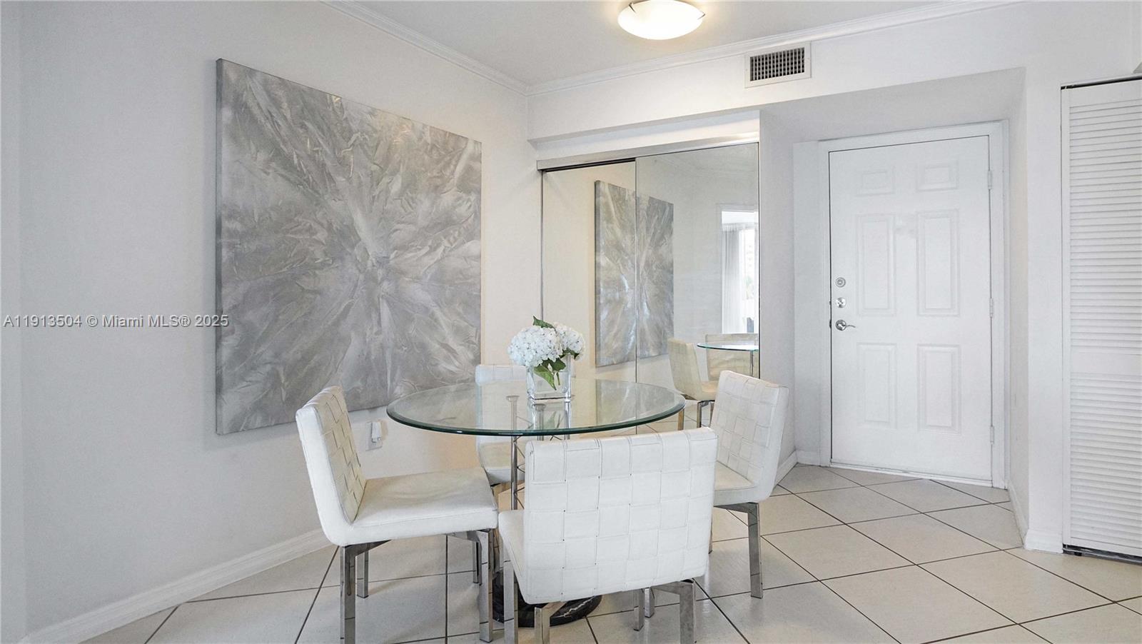 1621 Bay Road, Unit 606 Miami Beach, FL 33139 - Photo 4 of 32 a view of a dining room with furniture and wooden floor