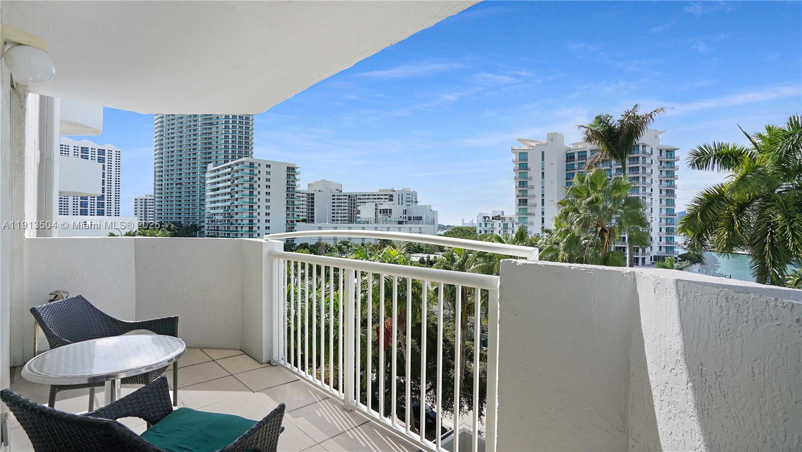 1621 Bay Road, Unit 606 Miami Beach, FL 33139 - Photo 9 of 32 a view of a chair and table in the balcony