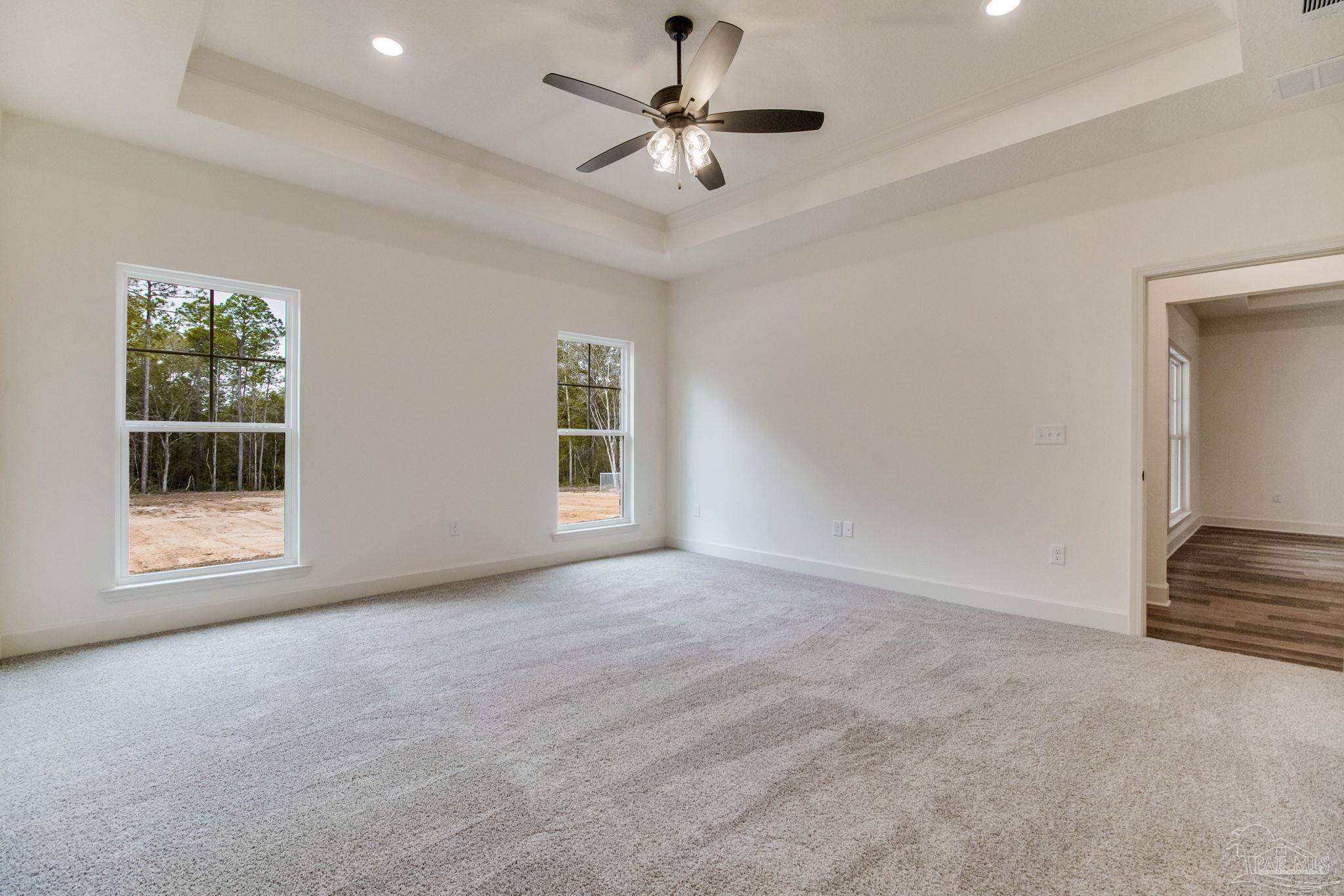 4310 Watkins Street Pace, FL 32571 - Photo 35 of 58 an empty room with windows and fan