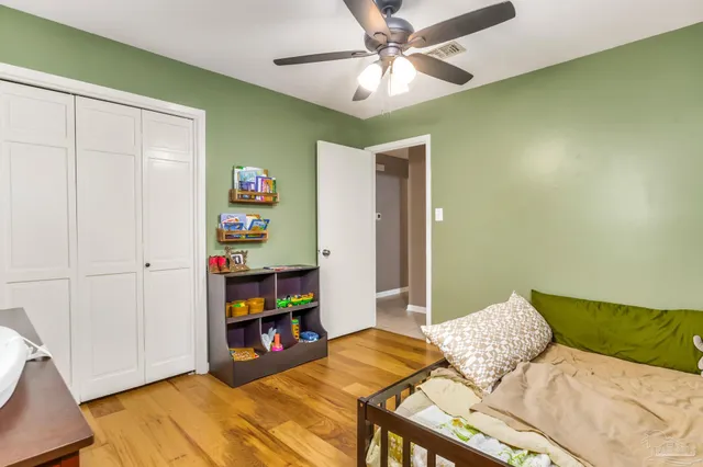 a bedroom with furniture and a book shelf