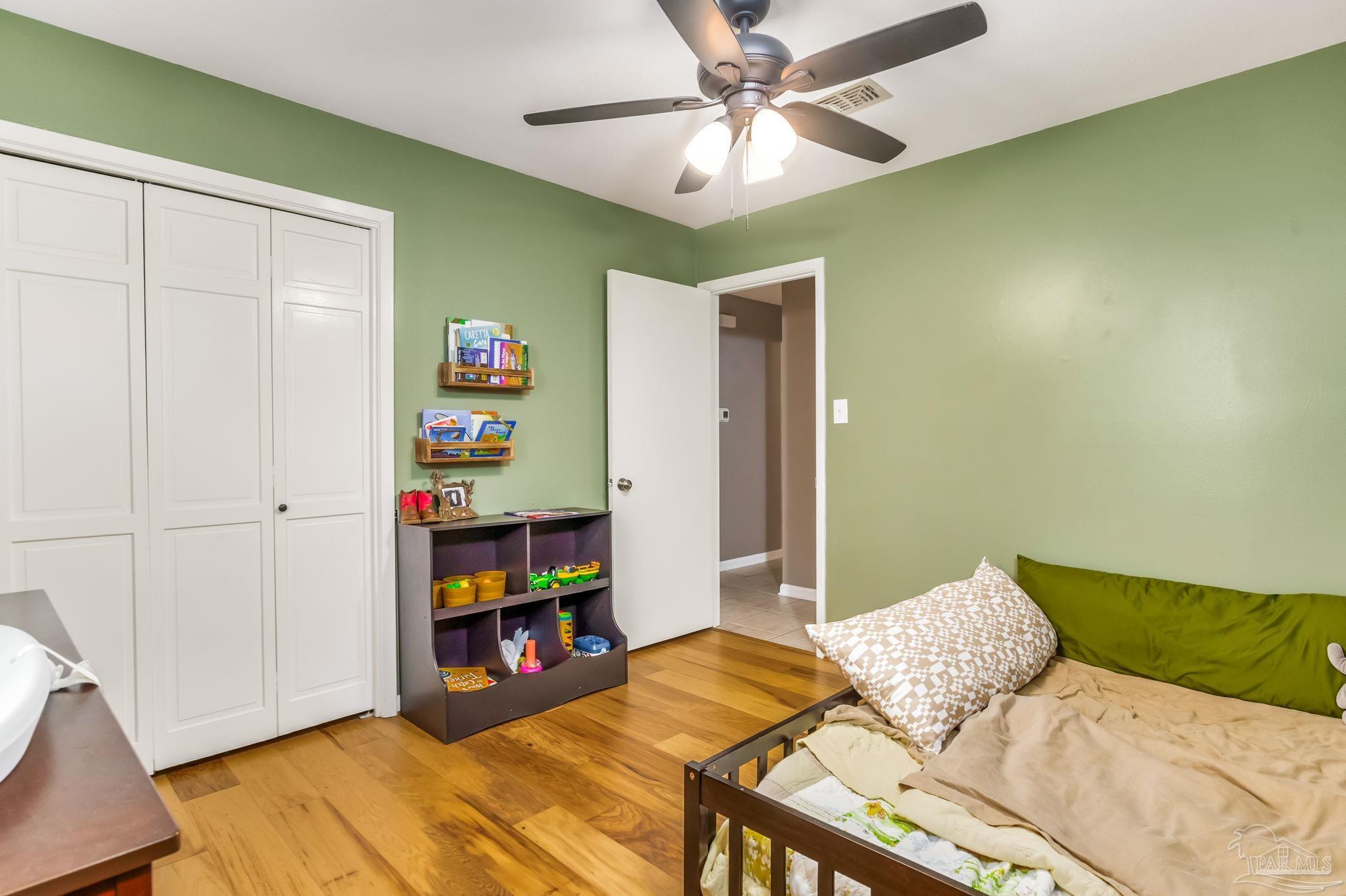 3525 Hopestill Road Pensacola, FL 32503 - Photo 11 of 20 a bedroom with furniture and a book shelf