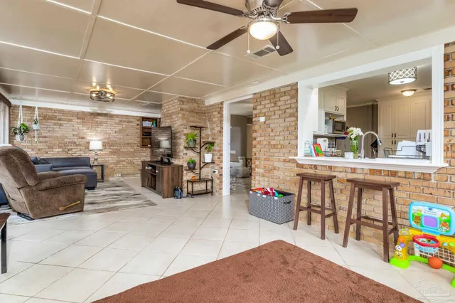 a kitchen with stainless steel appliances kitchen island granite countertop a refrigerator and microwave