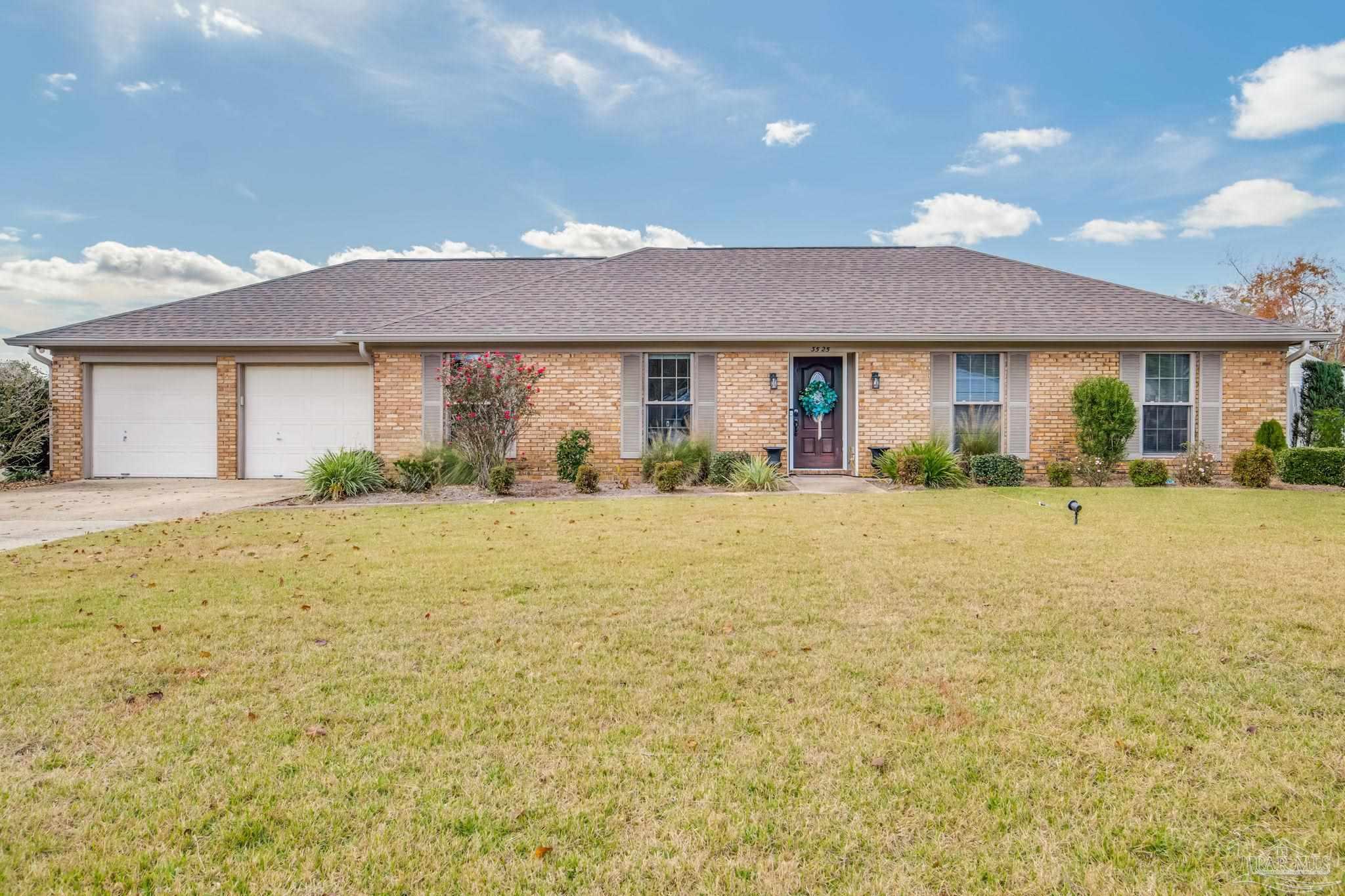 3525 Hopestill Road Pensacola, FL 32503 - Photo 2 of 20 a front view of a house with a yard and potted plants