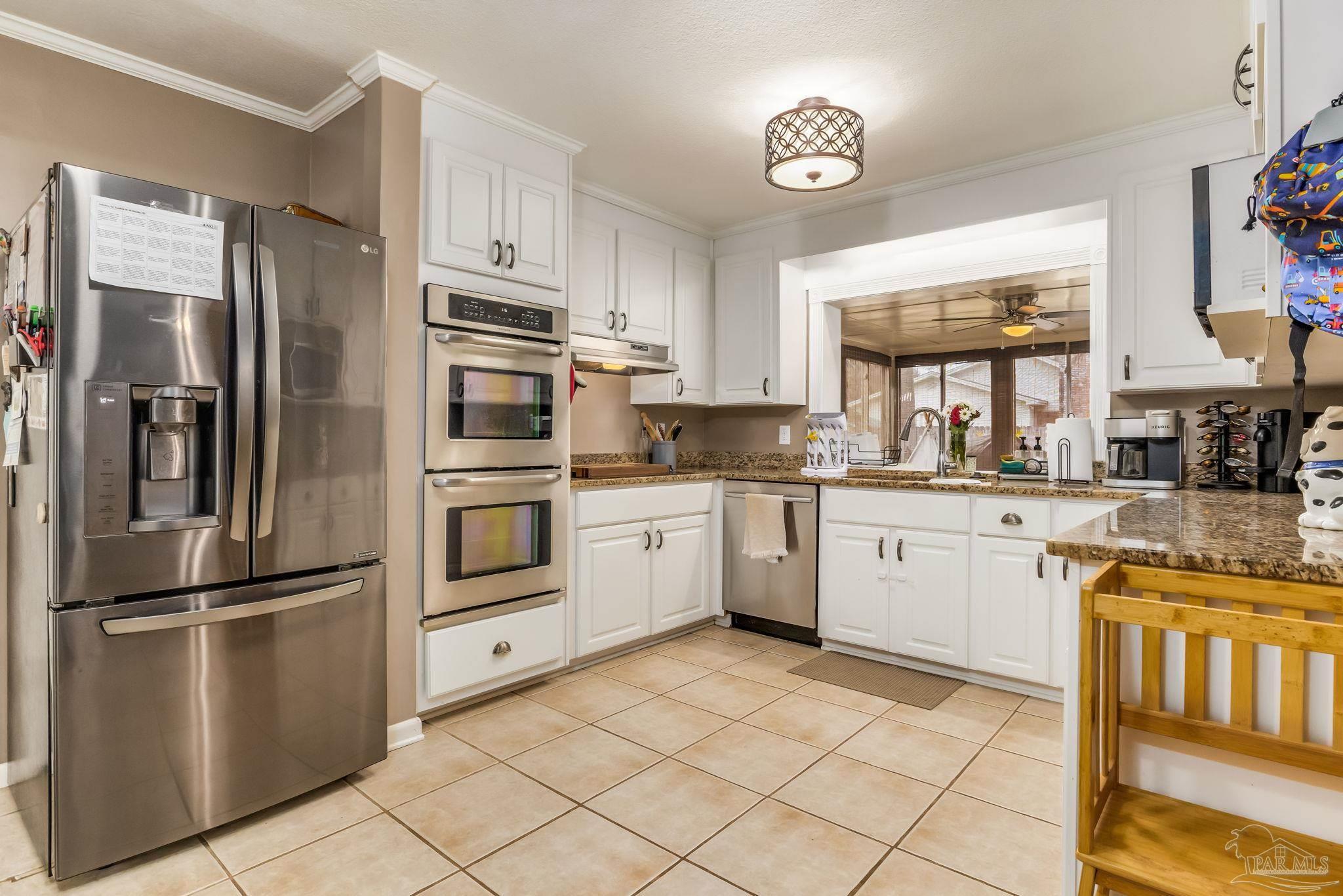 3525 Hopestill Road Pensacola, FL 32503 - Photo 6 of 20 a kitchen with granite countertop a refrigerator stove top oven and sink