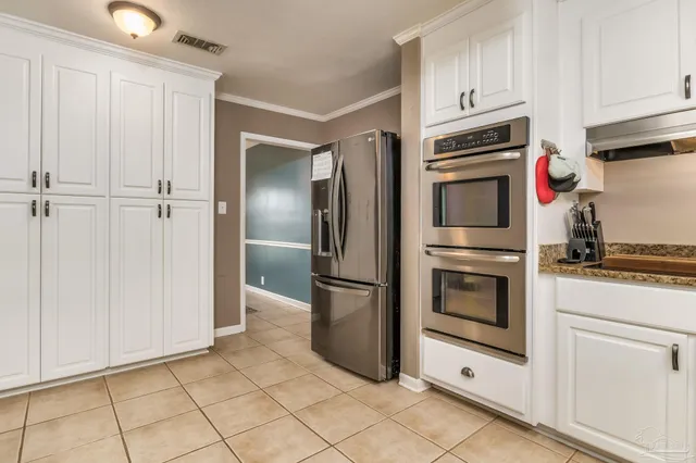 a kitchen with cabinets and stainless steel appliances