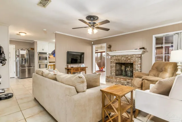 a living room with furniture a fireplace and a flat screen tv