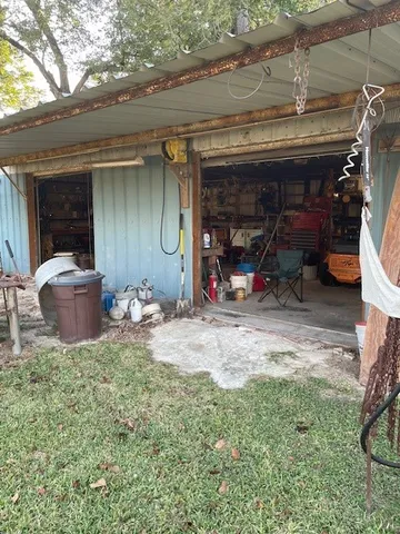 a view of a garage with a bike and car