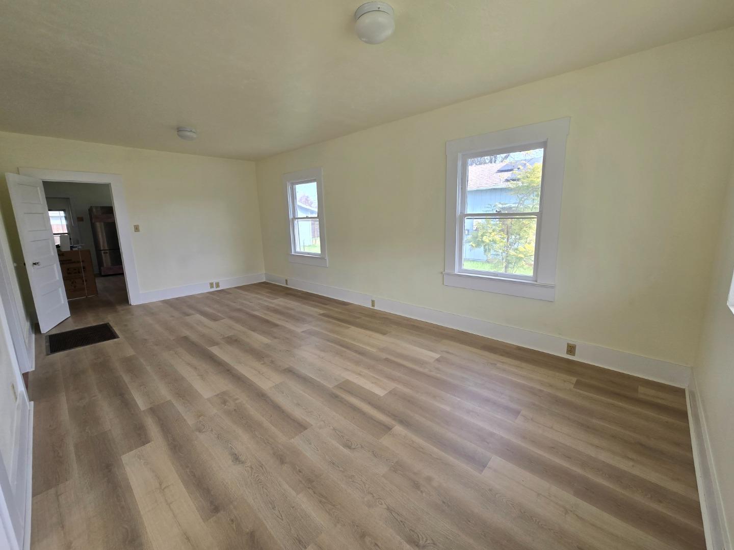 143 Oregon Street Ripon, CA 95366 - Photo 4 of 14 a view of a livingroom with wooden floor and a window