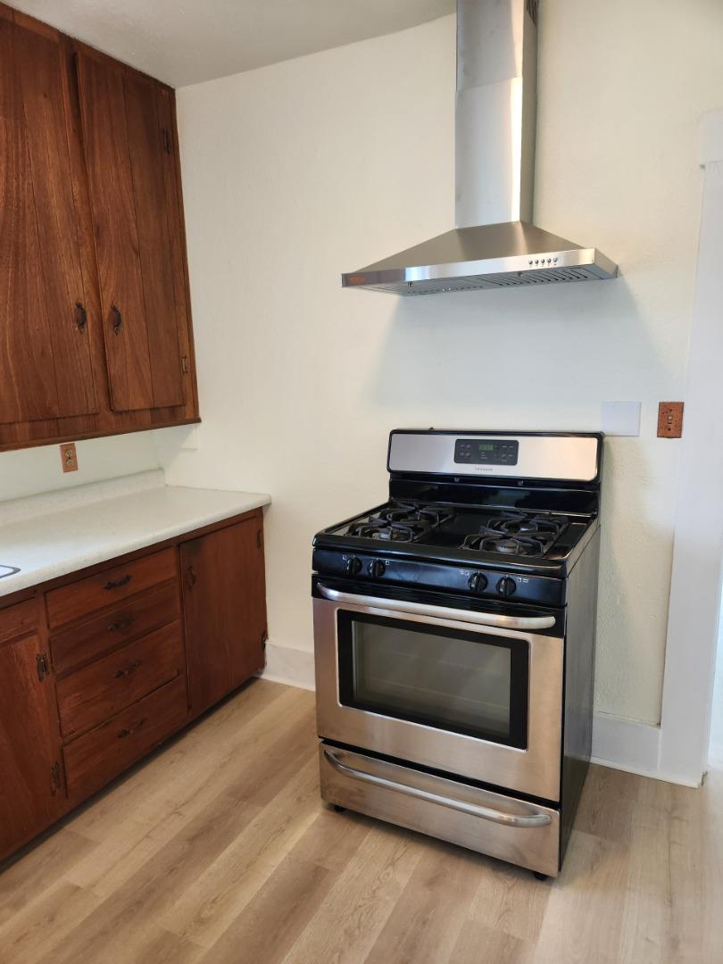 143 Oregon Street Ripon, CA 95366 - Photo 6 of 14 a stove top oven sitting inside of a kitchen