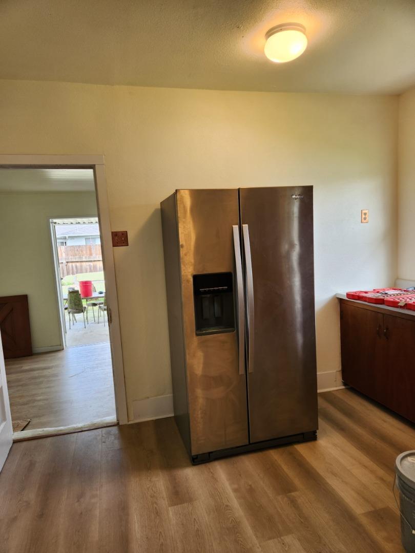 143 Oregon Street Ripon, CA 95366 - Photo 8 of 14 a view of a refrigerator in kitchen and an empty room