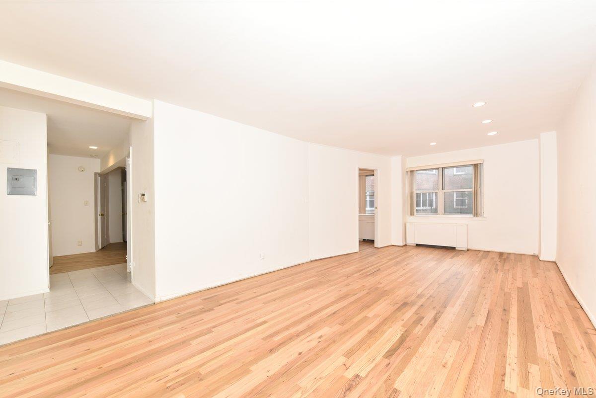 180 South Middle Neck Road, Unit 2A Great Neck, NY 11021 - Photo 3 of 24 a view of an empty room with wooden floor and a window