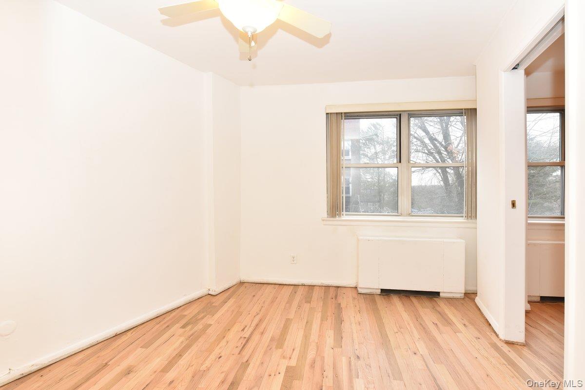180 South Middle Neck Road, Unit 2A Great Neck, NY 11021 - Photo 5 of 24 an empty room with wooden floor and windows