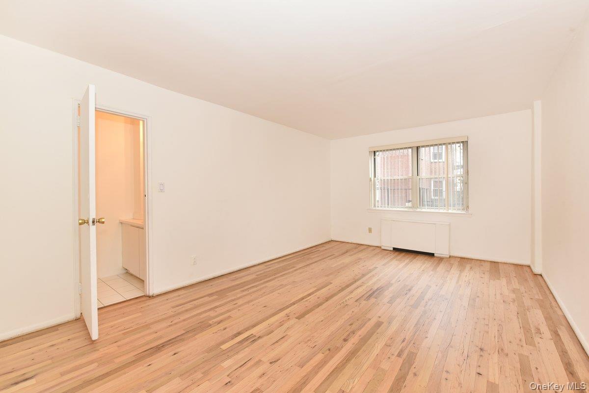 180 South Middle Neck Road, Unit 2A Great Neck, NY 11021 - Photo 7 of 24 an empty room with wooden floor closet and windows
