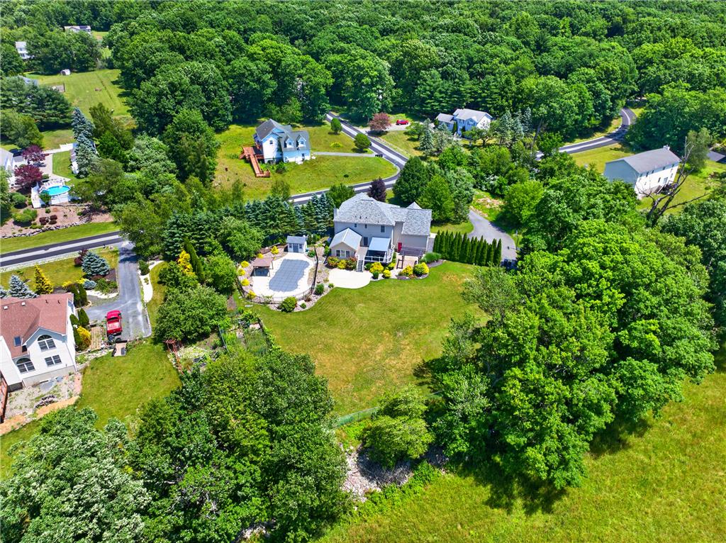 220 Pennbrook Road Stroudsburg, PA 18360 - Photo 59 of 60 An aerial perspective reveals a private pool with ample surrounding green space, offering a serene escape.