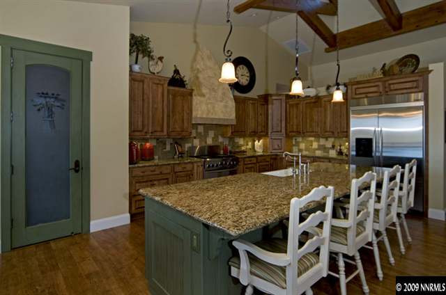 2665 Majestic View Court Reno, NV 89521 - Photo 4 of 9 a kitchen with stainless steel appliances granite countertop a sink a refrigerator and chairs