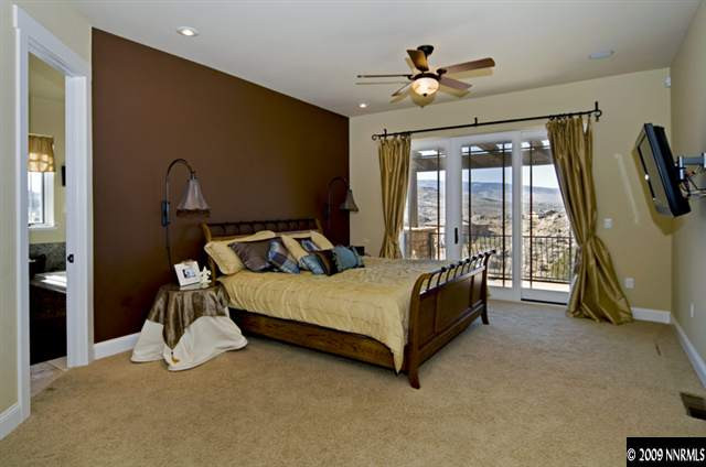 2665 Majestic View Court Reno, NV 89521 - Photo 6 of 9 a bedroom with a bed and a chandelier