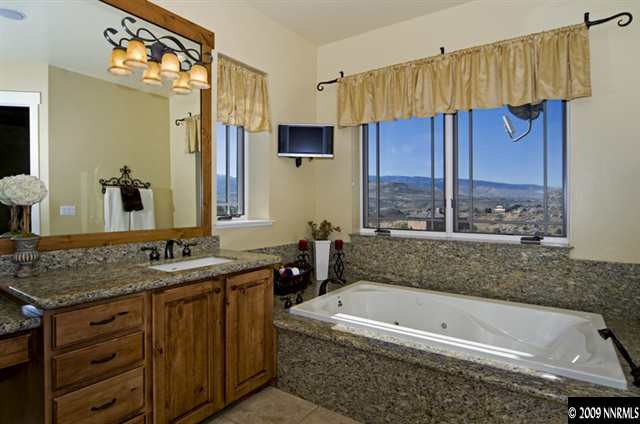 2665 Majestic View Court Reno, NV 89521 - Photo 7 of 9 a bathroom with a tub a sink and a large mirror