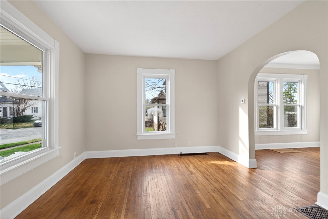 585 North Spring Street Wilmington, OH 45177 - Photo 5 of 21 This bright living space features elegant hardwood floors and abundant natural light through multiple windows.
