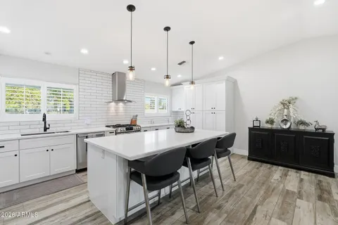 a kitchen with a sink stove and white cabinets