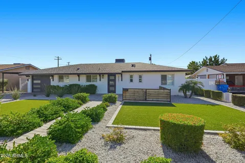a front view of a house with swimming pool having outdoor seating