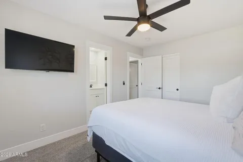 a bedroom with a bed and a flat screen tv