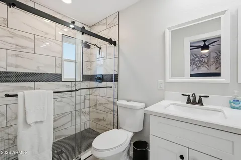 a bathroom with a sink toilet and shower
