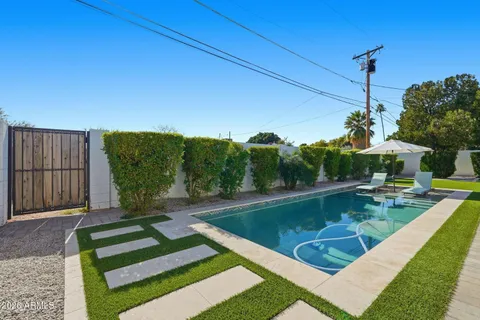 a view of a swimming pool with a patio