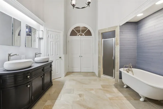 a spacious bathroom with a granite countertop sink and a mirror