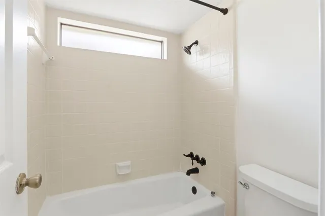 a bathroom with a tub and shower