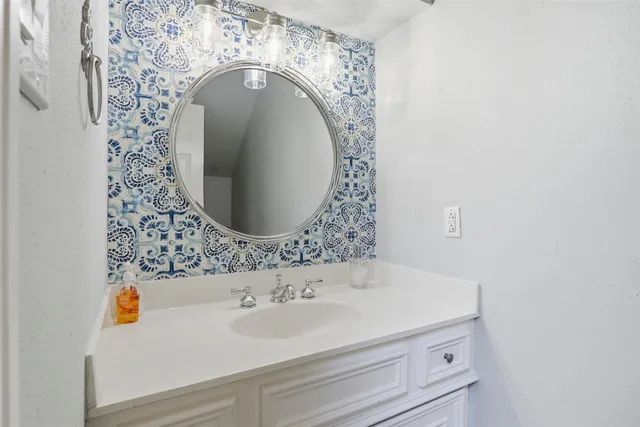 a bathroom with a sink and a mirror