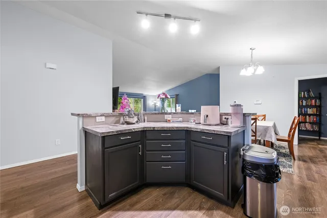 a kitchen with a sink cabinets and wooden floor
