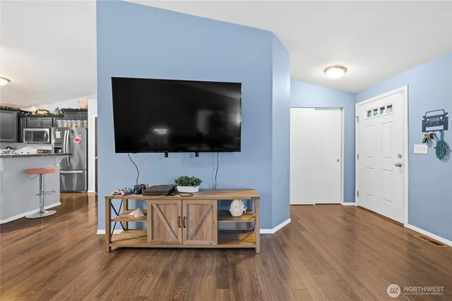 a living room with a flat screen tv a couch and a flat screen tv