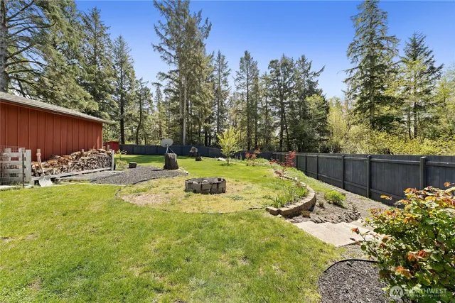 a view of a backyard with wooden fence
