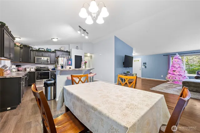 a view of a dining room with furniture and a kitchen