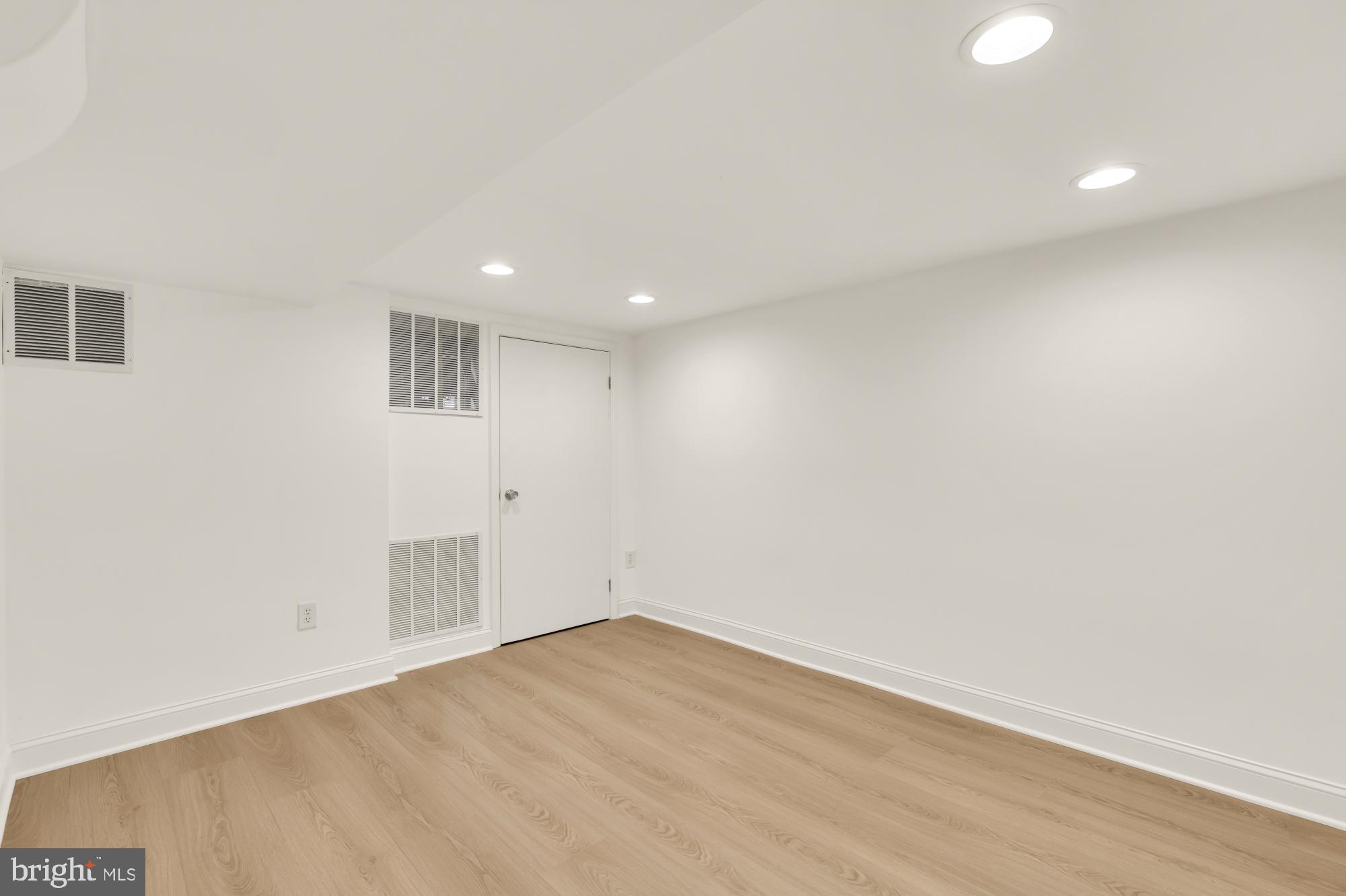 2030 Luzerne Avenue Silver Spring, MD 20910 - Photo 22 of 25 an empty room with wooden floor and windows