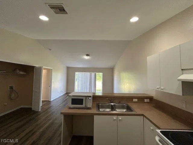a kitchen with a sink appliances and cabinets