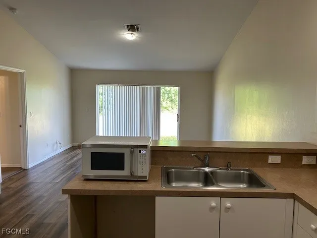 a kitchen with a sink and a microwave