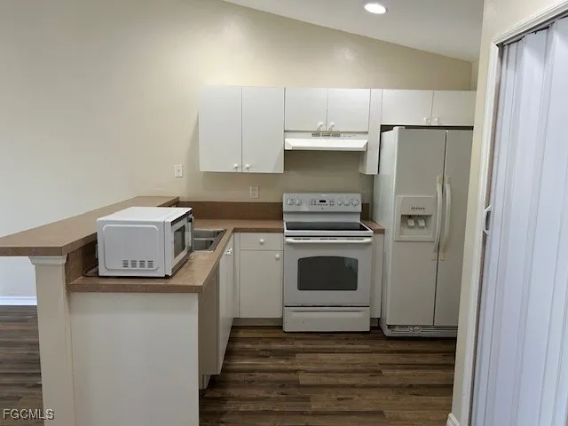 a kitchen with a stove and a refrigerator