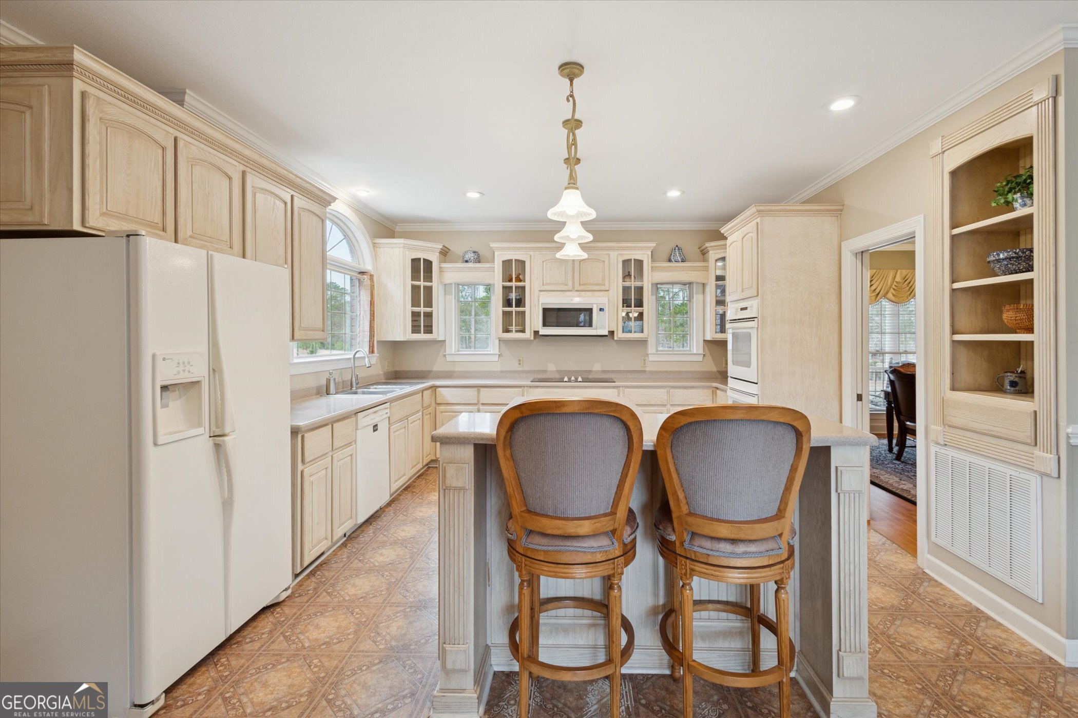 10544 Burkhalter Road Statesboro, GA 30461 - Photo 17 of 67 a kitchen with refrigerator cabinets dining table and chairs
